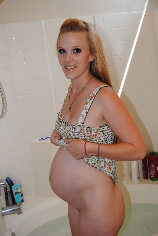 Беременная девушка с большим животиком принимает ванну и моется в душе 2 из 17 фото