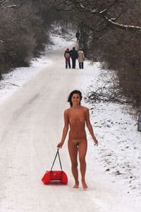 Голая девушка катается на санках зимой